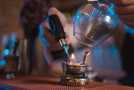 Man using professional burner to make drink with strainerの写真素材