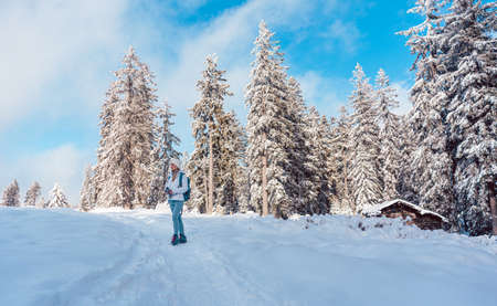 Hiking in the snow on a mountain slope in winterの写真素材
