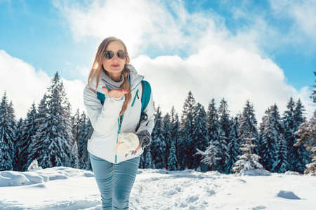 Woman loving her winter hike in the mountainsの写真素材