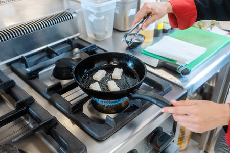 Chef frying lard on hearthの写真素材