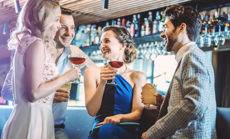 Four friends in a barの写真素材