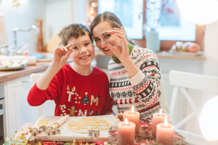 Mother and son playing with cookie cutter in the Christmas kitchenの写真素材