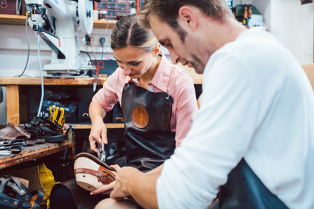 Two cobblers working together in the workshop