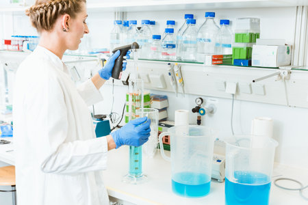 Female researcher testing chemicals in laboratoryの写真素材