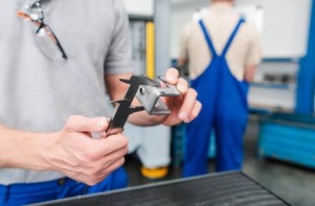 Workers discussing quality of a manufactured product for industrialの写真素材
