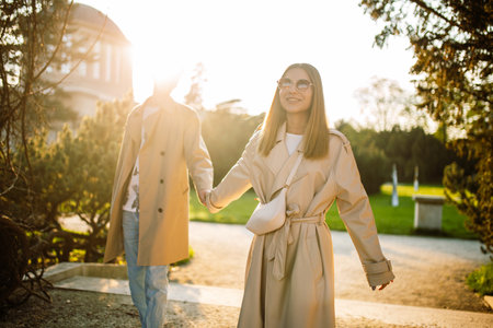 A young loving couple walking in the park in the spring at sunset. The concept of unity with natureの写真素材