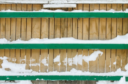background wooden fence in the snowの写真素材