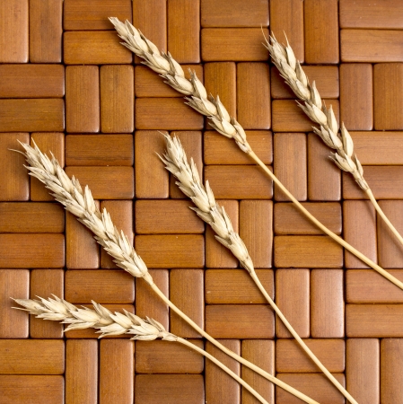 wheat ears on the wooden backgroundの写真素材