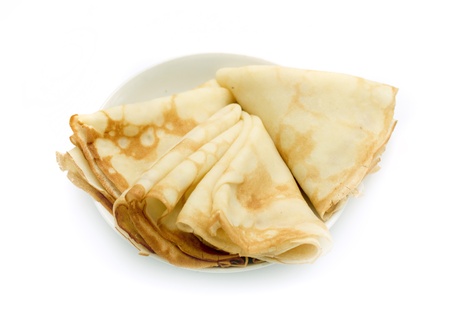 a lot of pancakes on a plate isolated on white backgroundの写真素材