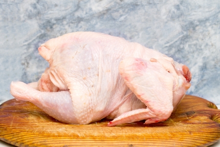 chicken for cooking food on a wooden boardの写真素材