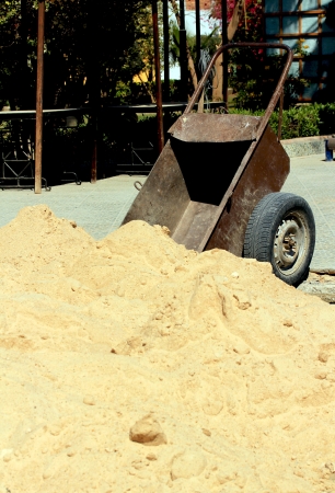 wheelbarrow of sandの写真素材