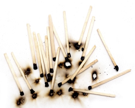 burnt matches on a white backgroundの写真素材