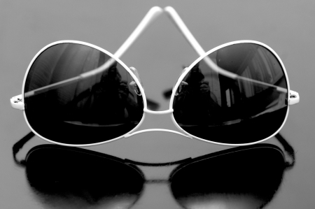 glasses in a white frame on a dark backgroundの写真素材
