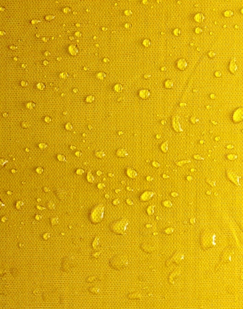 yellow background drops of waterの写真素材