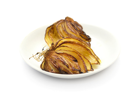 Fried onion with oil, on a white plateの写真素材