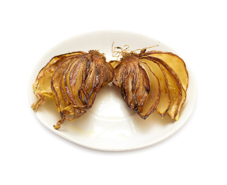 Fried onion with oil, on a white plateの写真素材