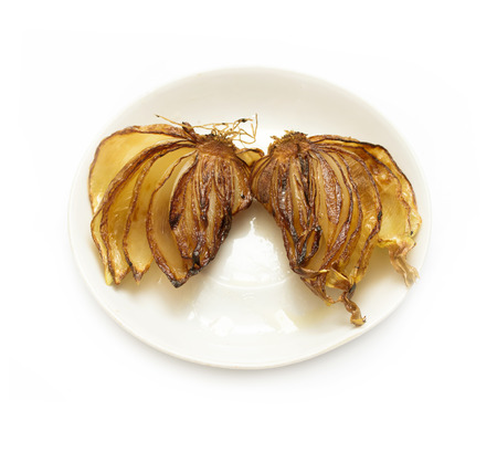Fried onion with oil, on a white plateの写真素材