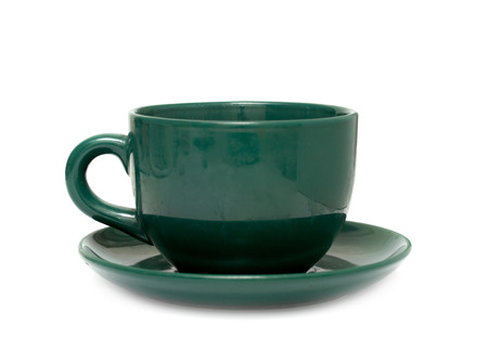 saucer with a cup of green on a white backgroundの写真素材