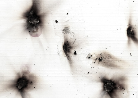 Fire holes in white paper