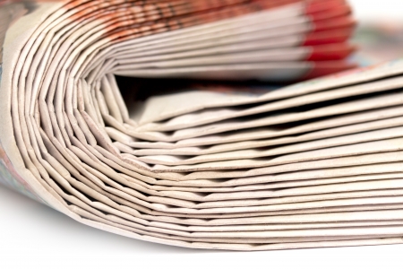 Newspapers folded and stacked concept for global communications