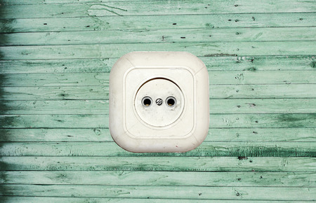 old white socket on a wooden backgroundの写真素材