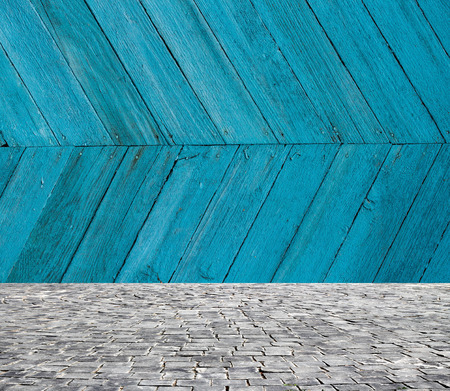 wooden fence rough background and vintage stone pavement foregroundの写真素材