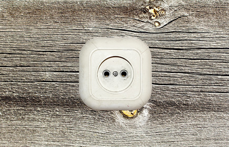 old white socket on a wooden backgroundの写真素材