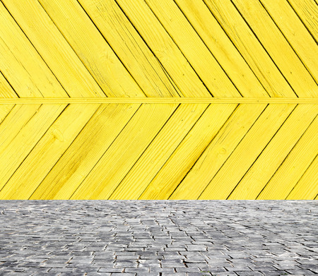 wooden fence rough background and vintage stone pavement foregroundの写真素材