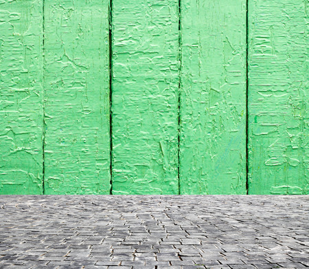 wooden fence rough background and vintage stone pavement foregroundの写真素材