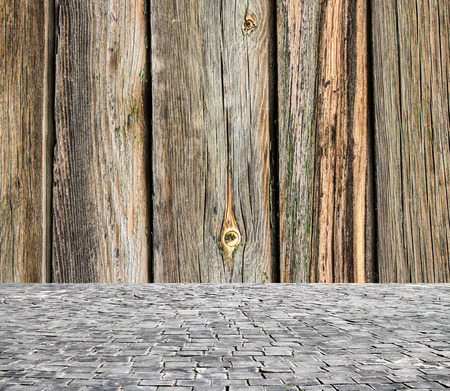 wooden fence rough background and vintage stone pavement foregroundの写真素材
