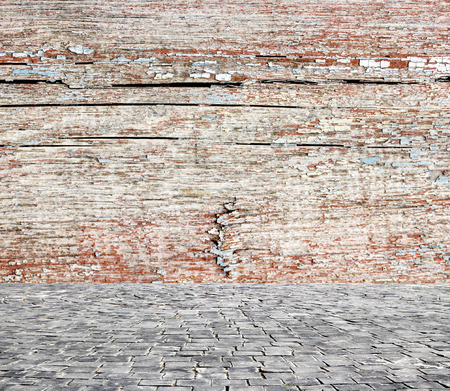 wooden fence rough background and vintage stone pavement foregroundの写真素材
