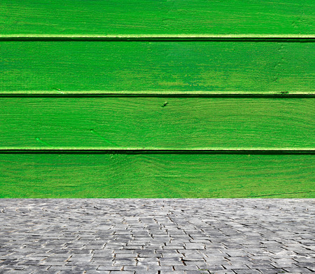 wooden fence rough background and vintage stone pavement foregroundの写真素材