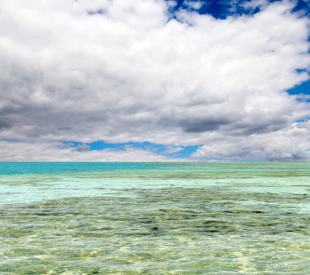 turquoise sea against the sky with cloudsの写真素材
