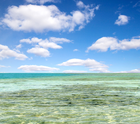 turquoise sea against the sky with cloudsの写真素材