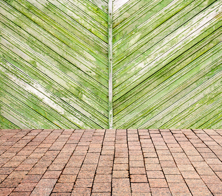 stone pavers on the background of wooden wallの写真素材