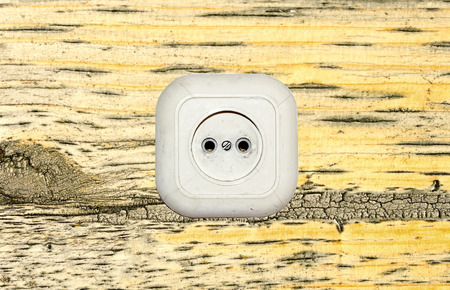 old white socket on a wooden backgroundの写真素材