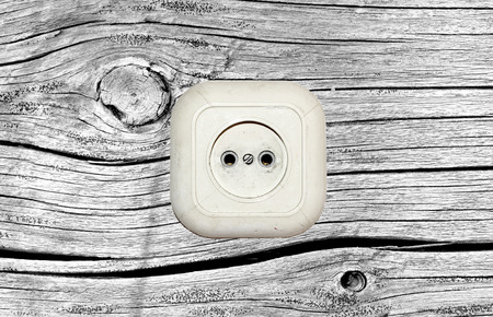old white socket on a wooden backgroundの写真素材