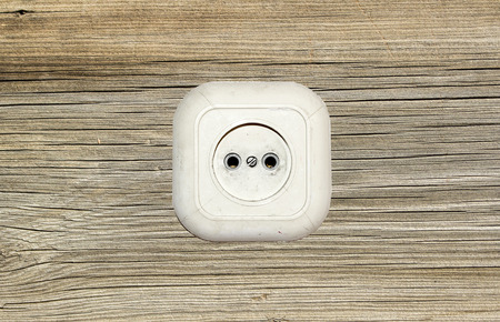 old white socket on a wooden backgroundの写真素材