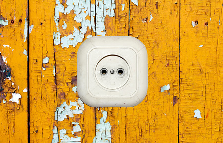 old white socket on a wooden background