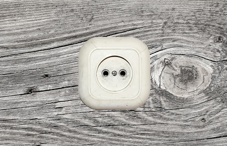 old white socket on a wooden backgroundの写真素材