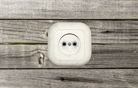 old white socket on a wooden backgroundの写真素材