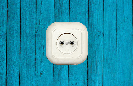 old white socket on a wooden backgroundの写真素材