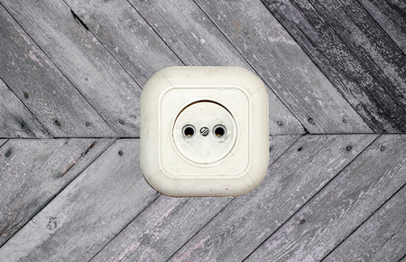 old white socket on a wooden background