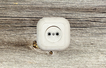 old white socket on a wooden backgroundの写真素材
