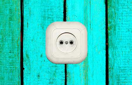 old white socket on a wooden backgroundの写真素材