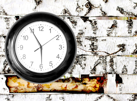 Wall Clock on Wooden Background