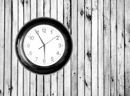 Wall Clock on Wooden Background