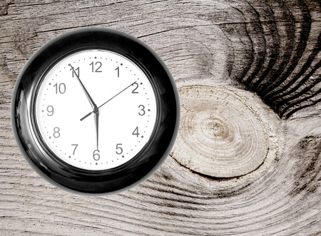 Wall Clock on Wooden Background