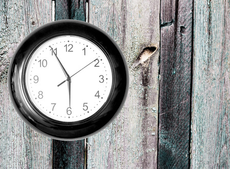 Wall Clock on Wooden Background