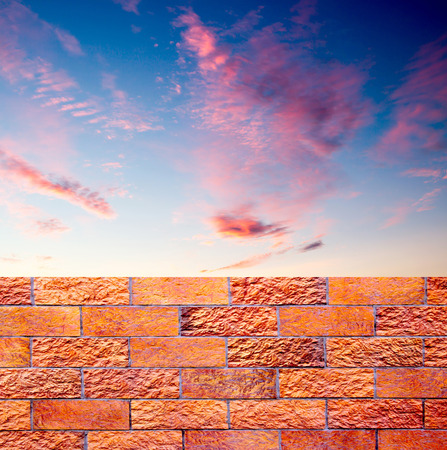 fence of decorative red brick wall against blue sky